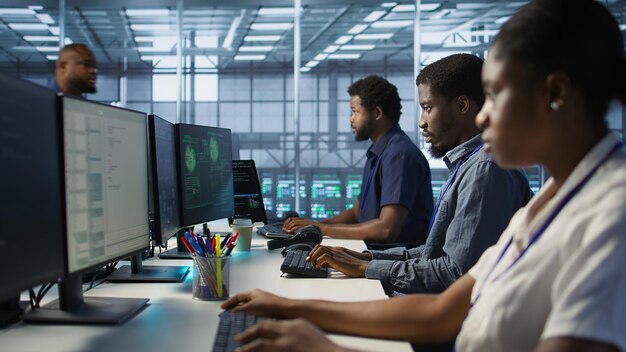Programmers in data center office doing teamwork to delete virus