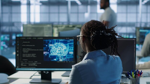 technician inspects rackmounts in server room using artificial intelligence tech