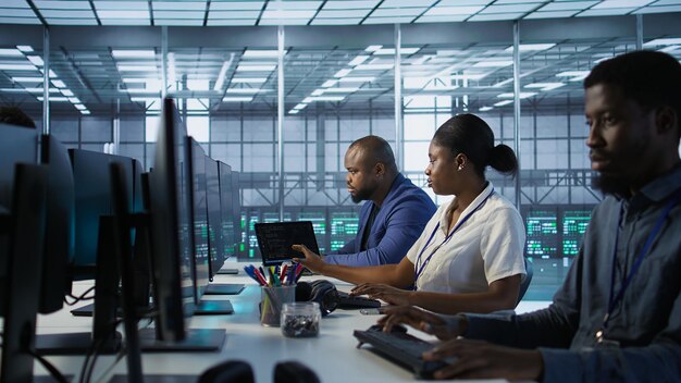 Technicians using computers and tablet in data center implementing AI