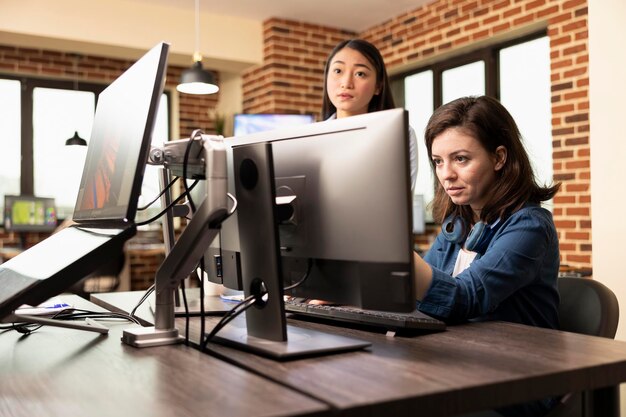 White woman analyzes designs on computer