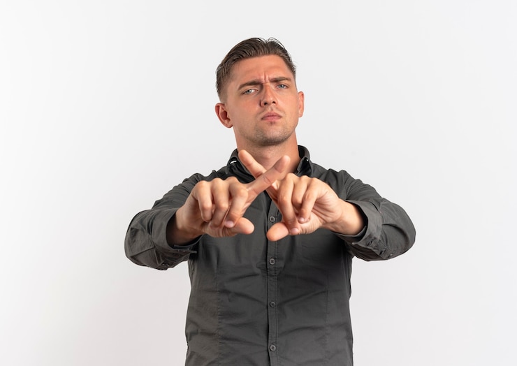Ilmainen Kuva young confident blonde handsome man crosses fingers looking at camera isolated on white background with copy space