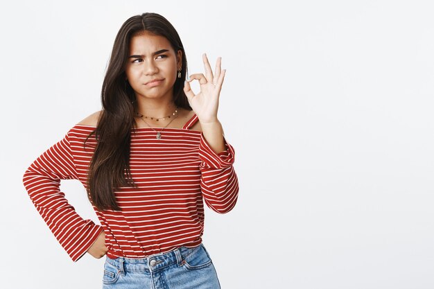 Une adolescente expressive dans un chemisier rayé