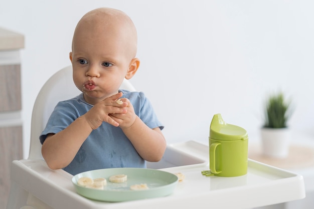 Adorable bébé jouant avec de la nourriture