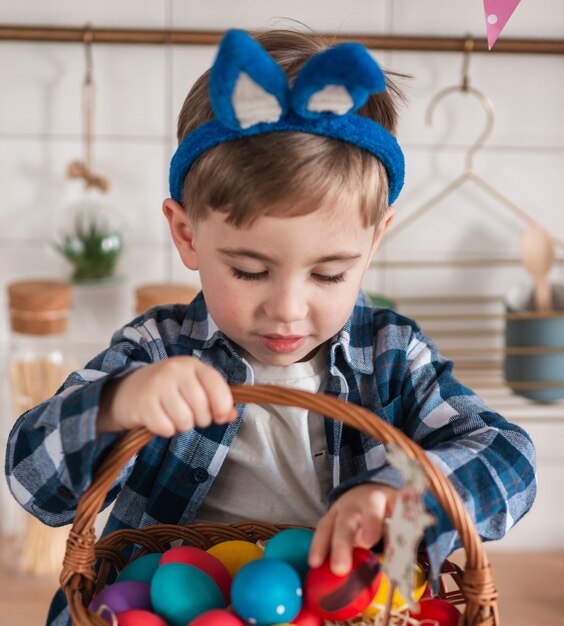 Adorable petit garçon jouant avec des oeufs de Pâques