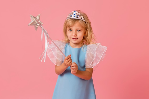 Adorable petite fille en costume et baguette