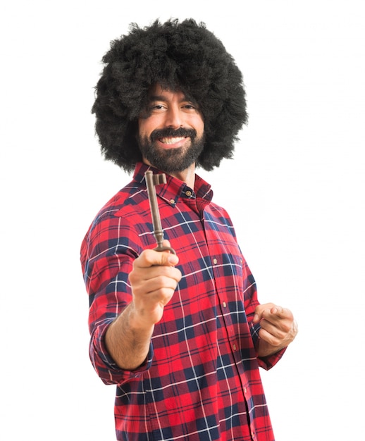 Afro man holding vintage key