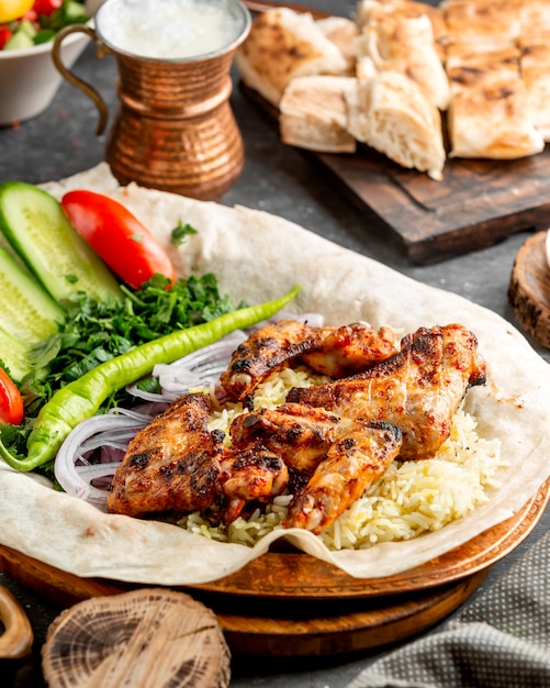 Ailes de poulet grillées servies avec riz et salade