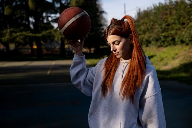 Amis d'âge moyen s'amusant ensemble en jouant au basket