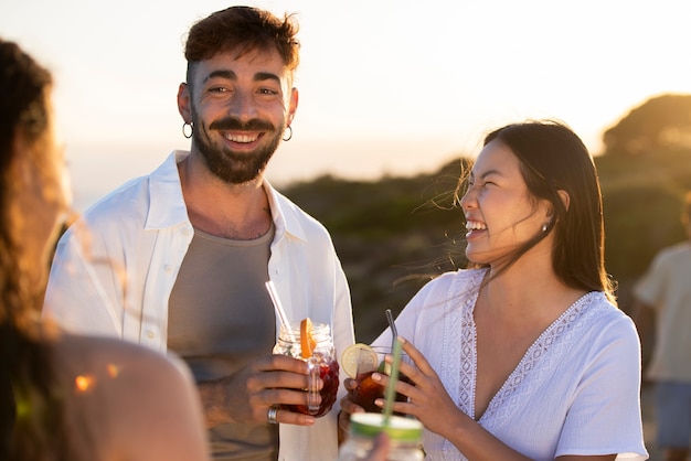 Amis ayant une soirée sangria au bord de la plage