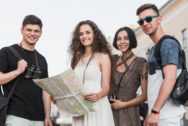 Amis debout avec des sacs à dos et carte