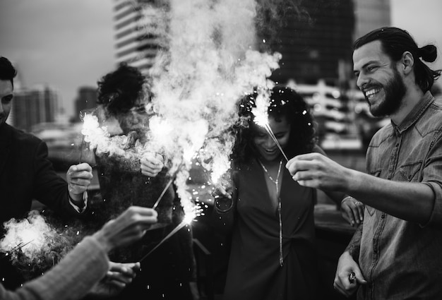 Amis jouant avec des feux de Bengale à l&#39;extérieur