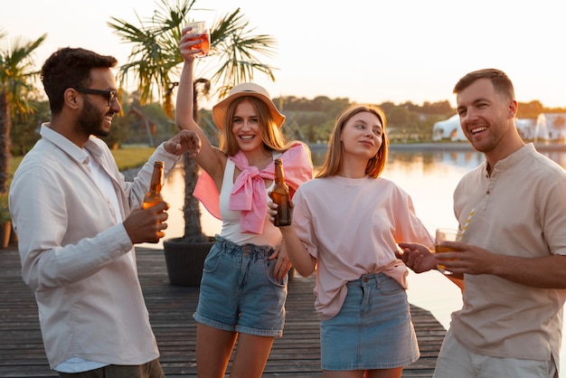 Amis vue de face avec un délicieux kombucha à l'extérieur