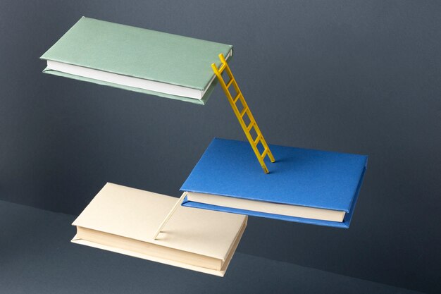 Angle élevé de livres flottants reliés par des échelles pour la journée de l'éducation