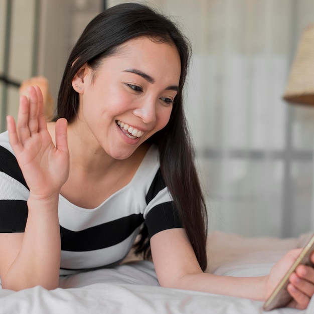 Appel vidéo femme au lit