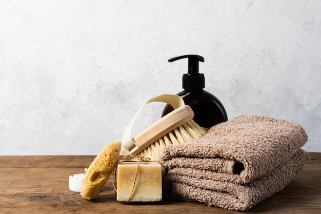 Photo gratuite arrangement de bain avec serviettes et brosse