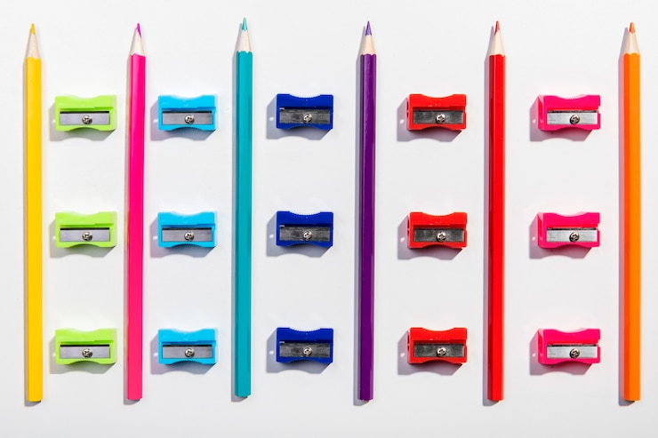 Photo gratuit arrangement de crayons colorés et taille-crayons vue de dessus