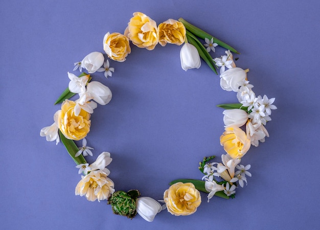 Arrangement de fleurs à plat sur fond bleu