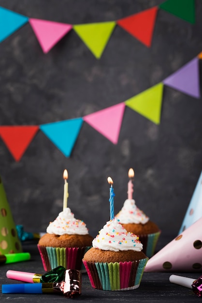 Arrangement avec des muffins et des bougies sur fond de bois