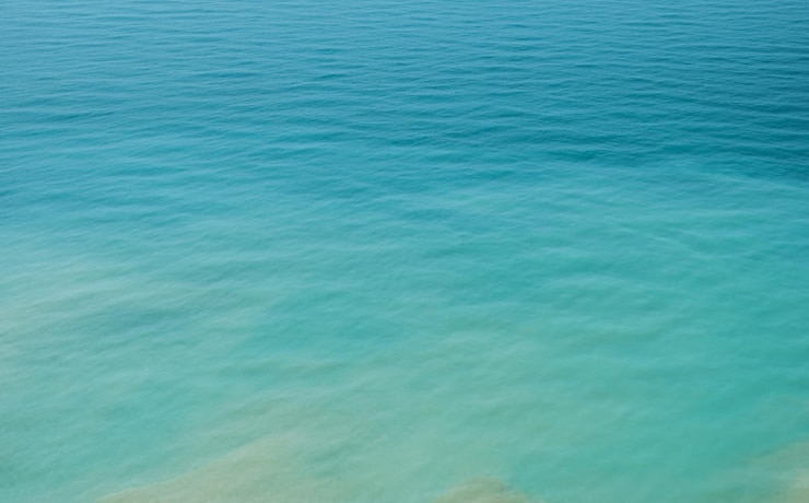 Photo gratuit arrière-plan flou de la mer dans la chaleur de midi depuis une vue à vol d'oiseau couleurs pastel de vacances d'été chaudes et reflets sur l'eau affiche de flou abstrait ou bannière publicitaire