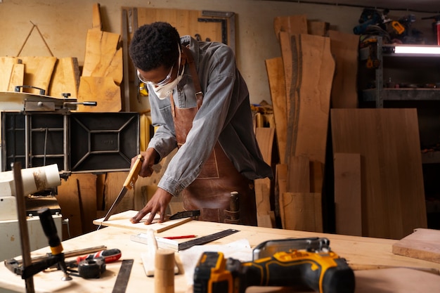 Photo gratuite artisan à coup moyen faisant de la coupe de bois