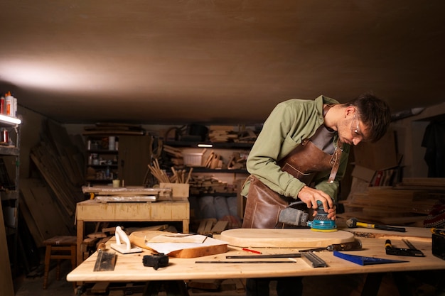 Photo gratuite artisan à coup moyen faisant de la coupe de bois