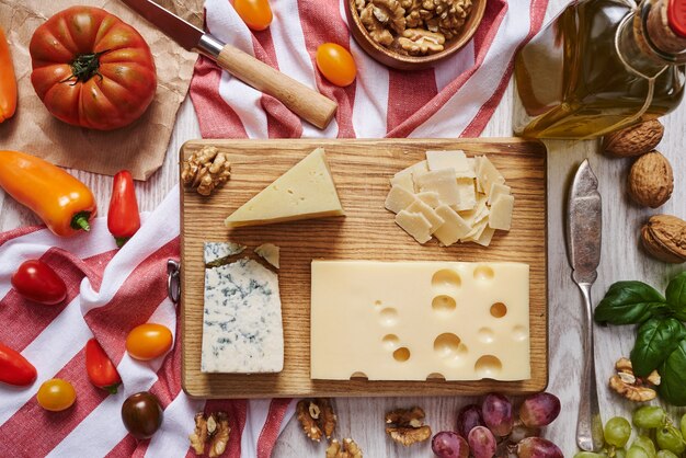 Assiette de fromage avec légumes et fournitures vue de dessus