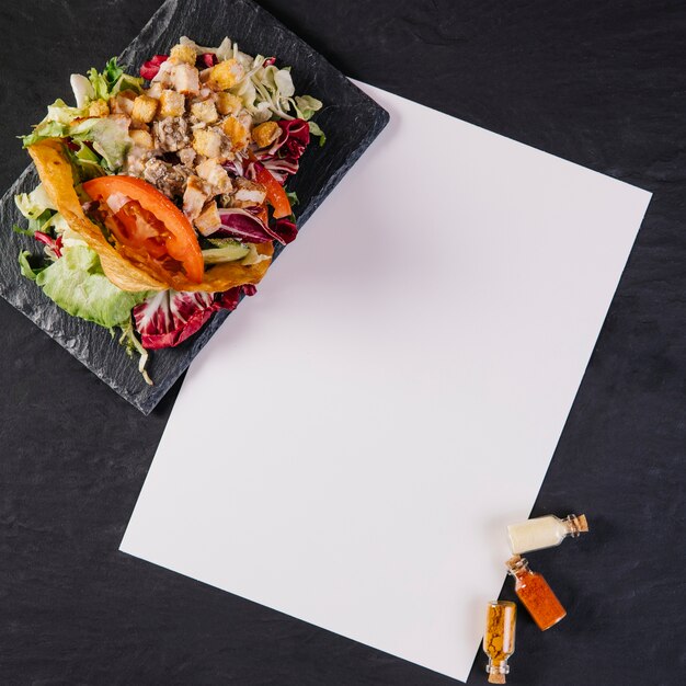 Assiette avec plat mexicain près de feuille de papier