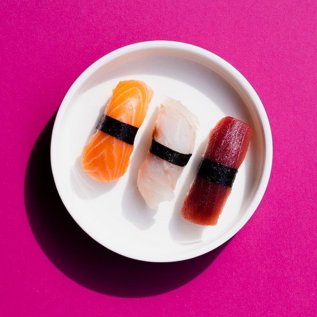 Assiette de sushi sur fond rose