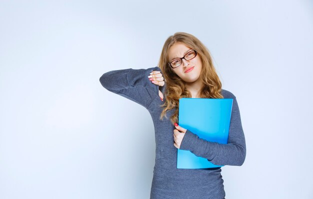 L'assistant avec le dossier bleu semble insatisfait.