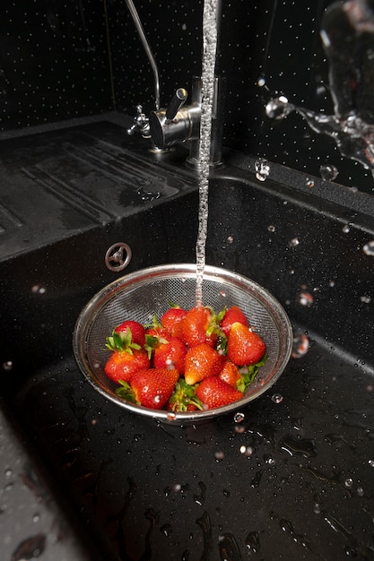 Photo gratuite assortiment de fraises en cours de lavage