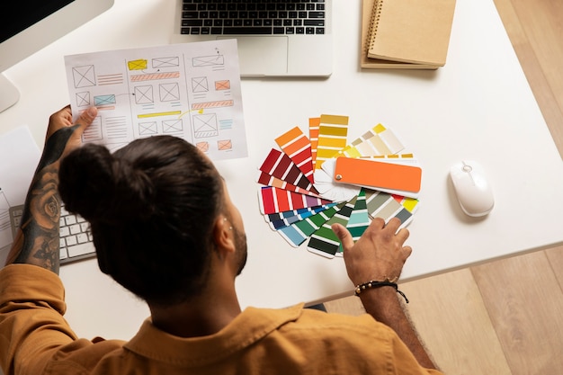 Photo gratuite au-dessus de la vue homme travaillant au bureau