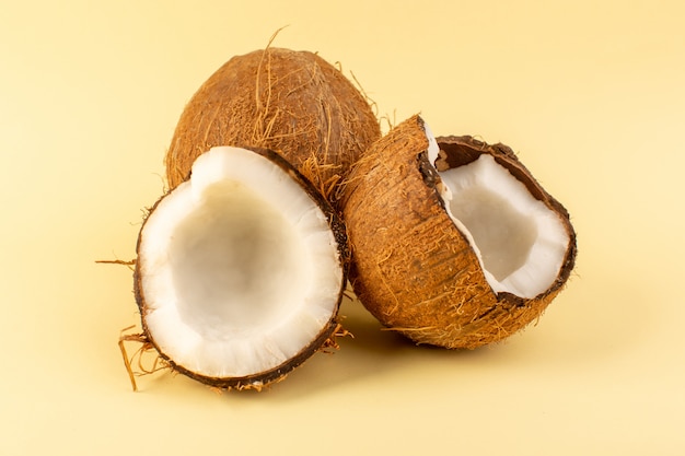 Un avant fermé vue de noix de coco en tranches laiteux frais moelleux isolé sur le fond de couleur crème noix de fruits exotiques tropicaux