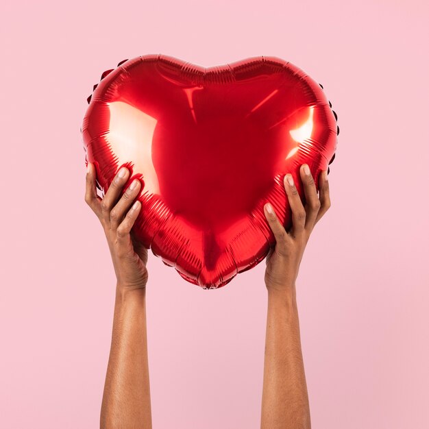 Ballon coeur Saint Valentin tenu par une personne