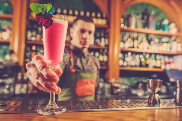 Photo gratuite barman offrant un cocktail alcoolisé au comptoir du bar sur le bar