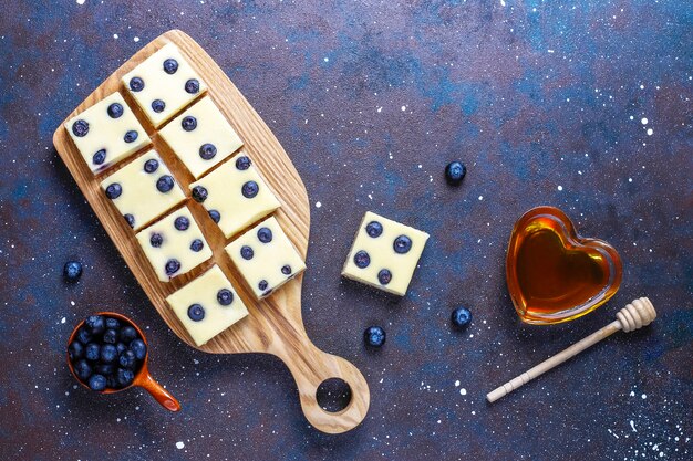 Barres de gâteau au fromage aux bleuets avec du miel et des baies fraîches