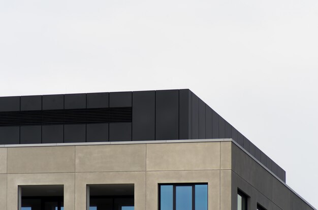 Un bâtiment en béton avec des miroirs sous le ciel clair