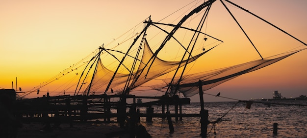 Beau coucher de soleil et épuisettes de pêche au fort de kochi en inde