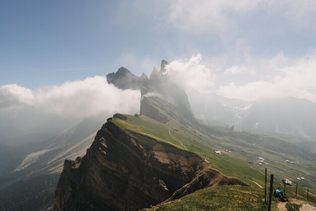 Beau coup de montagnes vertes couvertes de nuages blancs dans un ciel bleu clair