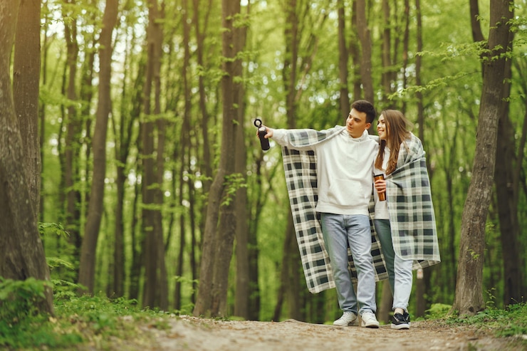 Photo gratuit beau couple passe du temps dans une forêt au printemps