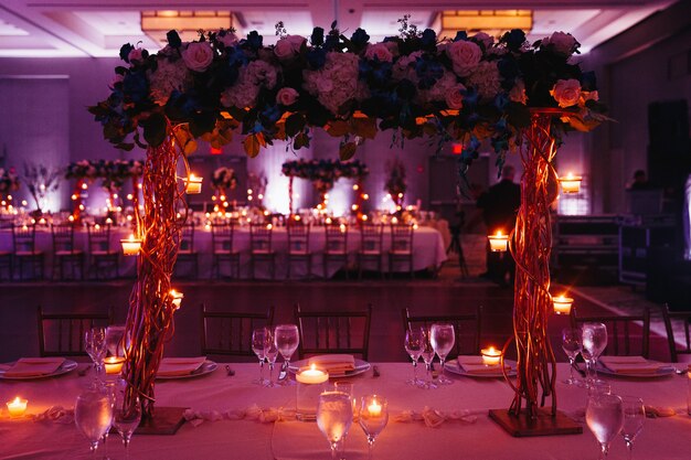 Beau mariage décoré rose servant avec pièce maîtresse et bougies éclairantes