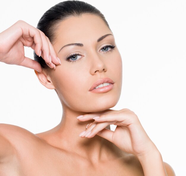 Beauté femme avec les mains au visage - isolé sur blanc