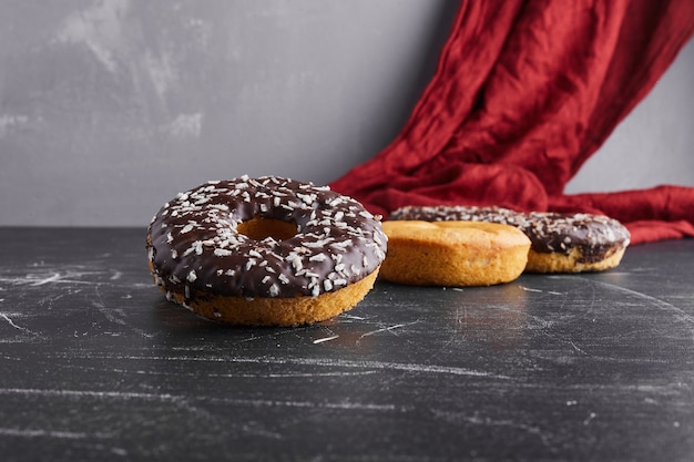 Beignets au chocolat sur une surface noire.