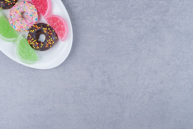 Beignets et marmelades alignés sur un plateau sur une surface en marbre