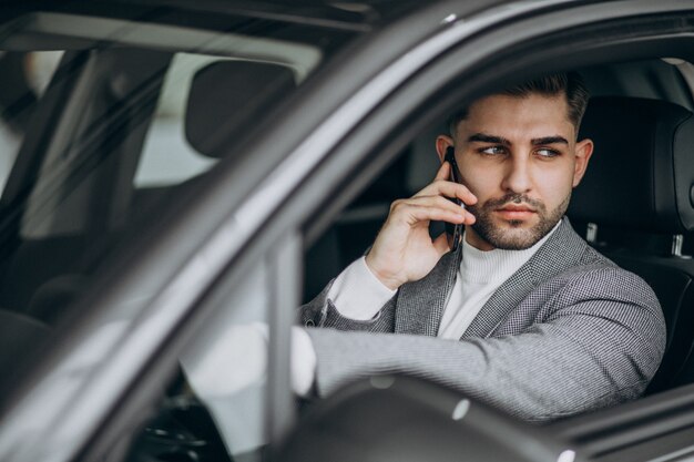 Bel homme d'affaires conduisant en voiture