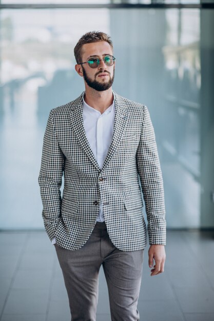 Bel homme d'affaires debout au bureau