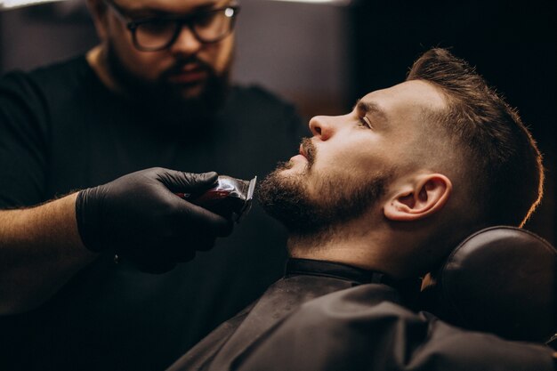 Bel homme coupe la barbe dans un salon de coiffure