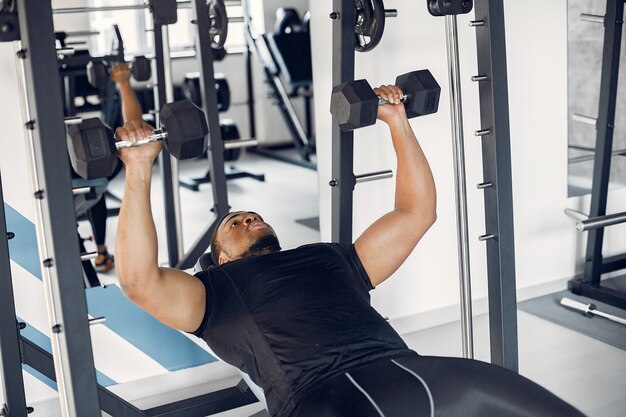 Un bel homme noir est engagé dans une salle de sport