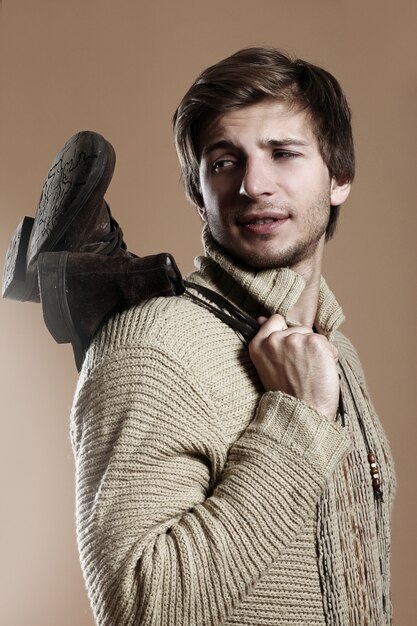 Bel homme portant des bottes et des vêtements d'hiver