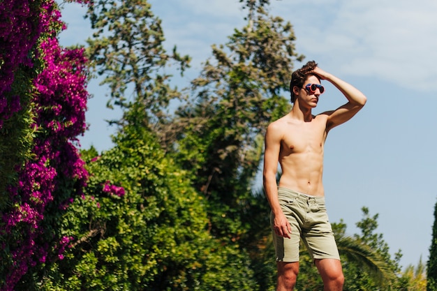 Bel homme torse nu posant avec des lunettes de natation