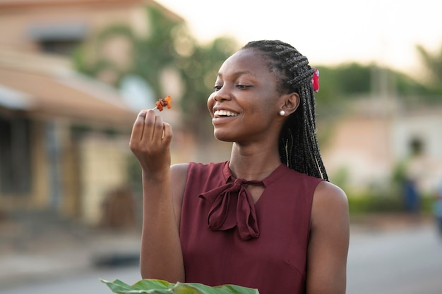 Belle femme appréciant de la nourriture de rue